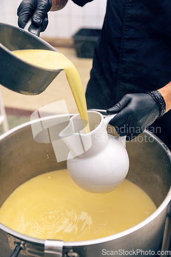 Image of Chicken broth pours into the serving jug
