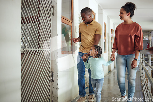 Image of Black family, animal shelter and planning adoption with mother, father and child walking together inside vet building for charity or volunteer work. Man, woman and girl together at pet ngo center