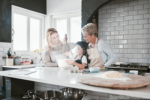 Image of .Grandmother, mother and girl baking in kitchen having fun, bonding and spend quality time together. Family, love and grandma and mom teaching child how to cook, bake and develop chef skills at home.