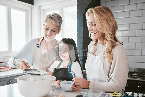 Image of Family, baking and cooking together in a home kitchen with mother, grandmother and child learning about food and being a chef of baker. Woman, senior and girl helping with flour for pancakes or cake