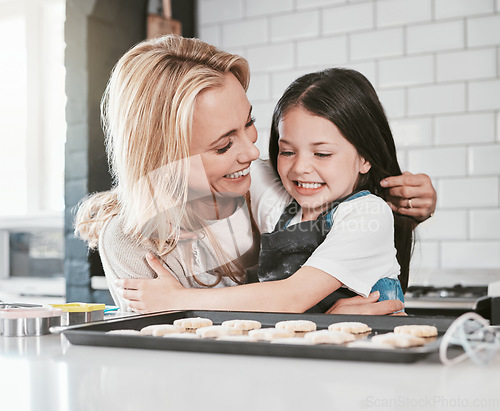 Image of Family, children and baking with a mother and daughter learning about cooking in the kitchen of their home together. Love, kids and bake with a girl and woman teaching her child about food in a house