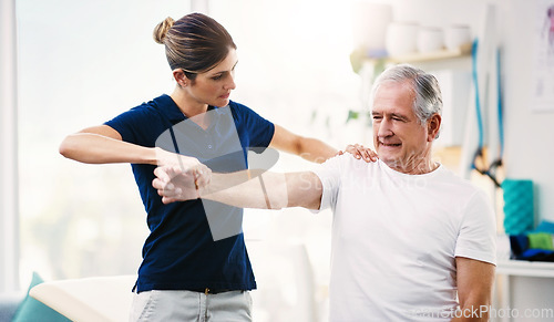 Image of Physiotherapist, senior man and patient stretching, health and wellness in office. Healthcare, mature male client and female medical professional help with injury, exercise and physiotherapy fitness.