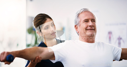 Image of Physical therapy, exercise and physiotherapist with a senior man helping him heal at a rehabilitation clinic. Healthcare, wellness and elderly guy doing a workout with weights in physiotherapy class.