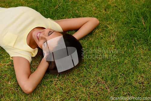 Image of Happy woman relax on park grass, garden and nature, freedom or rest on summer lawn with mockup. Above of young girl lying on green field outdoor in sunshine for calm, peace and mental health wellness