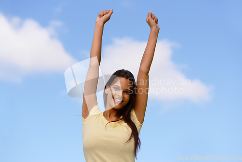 Image of Freedom, energy and woman in nature against a blue sky to relax with peace, happiness and smile. Excited, free and Indian girl in her youth happy with enthusiasm and enjoying outdoor living in summer