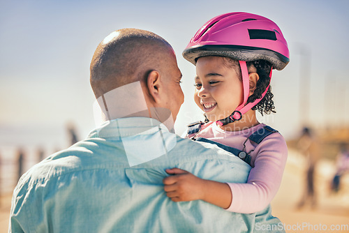 Image of Family, love and girl with dad and helmet for safety before cycling together at park outdoors, happy and hug. Children, learning and father embrace daughter, bonding and talking before riding a bike