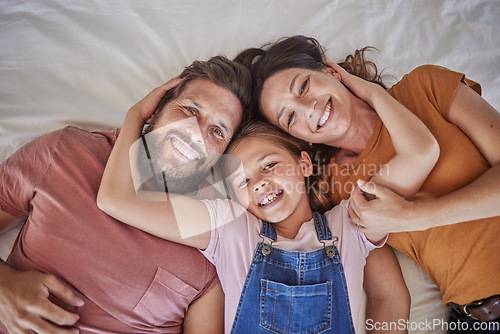 Image of Family, portrait and relax in bed by girl and parents resting from above, happy and smile in home together. Happy family, love and face of child with mom and dad in bedroom for bond and hug