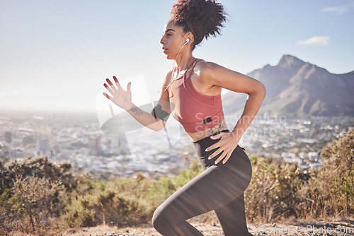 Image of Music, fitness and woman running along mountain, listening to radio while doing morning cardio, wellness and exercise. Sports, podcast and black woman focused on training, run and workout with energy