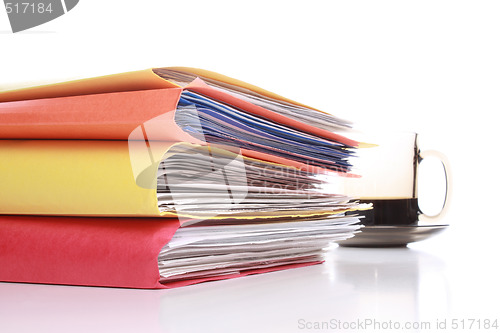 Image of Stack of folders with coffee