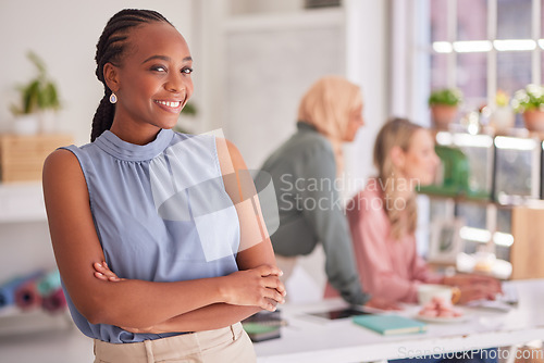 Image of Black woman, business portrait and arms crossed in startup company, marketing agency and office for goals, vision and motivation. Happy entrepreneur, professional employee and worker in modern office