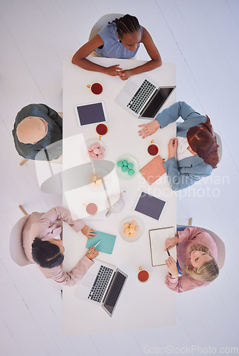 Image of Creative, meeting and business people in office from above, collaboration, discuss and digital planning at table. Business women, partnership and teamwork sharing strategy for goal, mission and idea