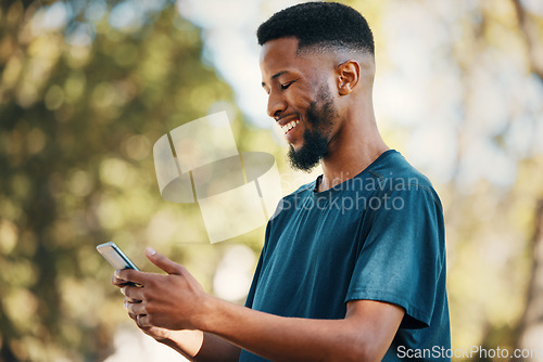 Image of Black man with smartphone, communication outdoor with technology, message or email with 5g network in nature. Online, social media and internet connection, check cellphone and smile at meme or text.