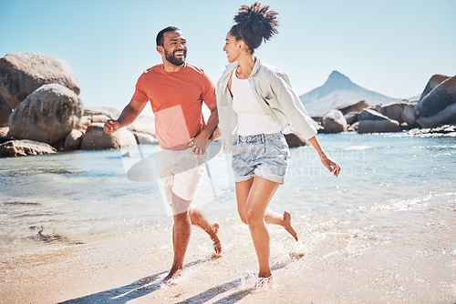 Image of Black couple, beach and running while happy on vacation in summer with energy, love and happiness while outdoor. Man and woman together by the sea for honeymoon, holiday and quality time in nature