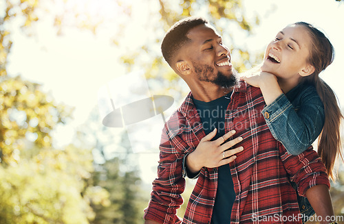 Image of Couple, hug and smile while outdoor with love and care in nature, happy together while bonding in park. Black man, woman and interracial, hugging in relationship and marriage with romance mock up.