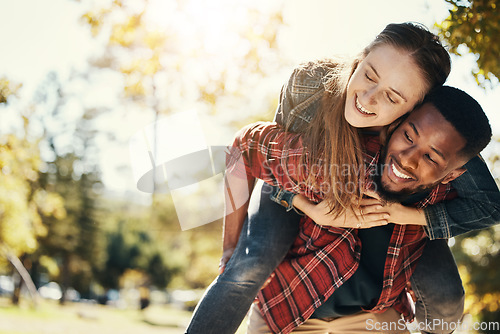 Image of Love, care and interracial couple with piggyback in a park for support, adventure and happy with mockup and bokeh. Hug, smile and black man and woman on an outdoor date in nature with space in summer