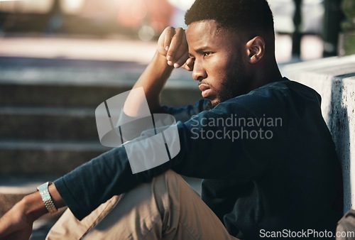 Image of Depressed, angry and black man upset, tired and unhappy outdoor in city, stare and frustrated. Mental health, African American male and young guy with problem, fail and depression being disappointed.