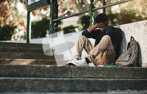 Image of Mental health, depression and anxiety with student on stairs with backpack for failure, fear and mistake. Sad, stress or bullying with black man on steps of college campus for frustrated or problem