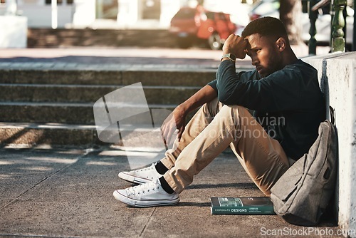 Image of Education, fail and stress with a black man student worried about an exam or test on university campus. College, sad and scholarship with a male pupil feeling depressed after a negative report