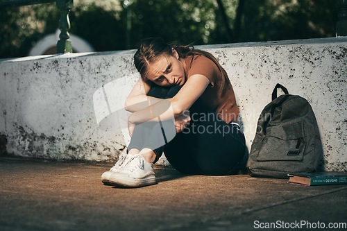 Image of Woman, student and depression in lonely stress, anxiety or mental health problems in the outdoors. Sad and depressed female teenager in distress, loneliness or trouble at school or university