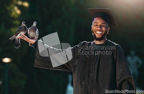 Image of Student portrait, graduate and pigeon with a smile, hat and cloak for graduation, celebration and achievement outdoor in park. University, college or school man with happiness for education success