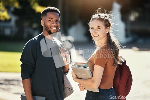 Image of Students, couple or university friends walking together with books for education and learning on campus with scholarship. Portrait of an interracial man and woman together on college or school ground