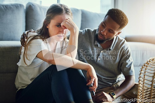 Image of Depression, sad and compassion with a man and woman comforting or consoling in a home living room. Couple, love and support with a male and female together in trust, hope or empathy for mental health