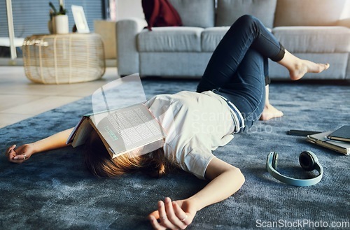 Image of Education, tired and book with a woman student lying on the floor of her living room, sleeping in a home. Learning, exhausted and reading with a female college pupil asleep in a house while studying
