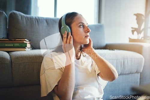 Image of Woman relax, music headphones and peace on living room sofa, sound and freedom, calm lifestyle or mindfulness. Young girl listening to meditation audio, web radio or streaming sound in apartment home