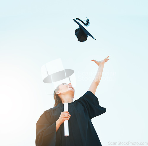 Image of Woman celebrate graduation hat in blue sky for success, achievement and goals of university certificate, college diploma and education motivation. Below of excited graduate and graduation cap in air