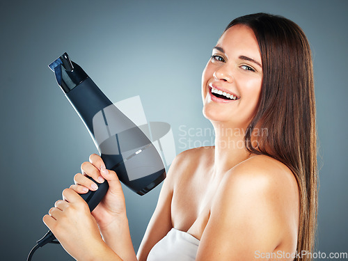 Image of Woman, hair dryer and salon with smile for beauty, skincare or cosmetics against a studio background. Portrait of happy female face smiling for hair care wellness or bathroom treatment on mockup