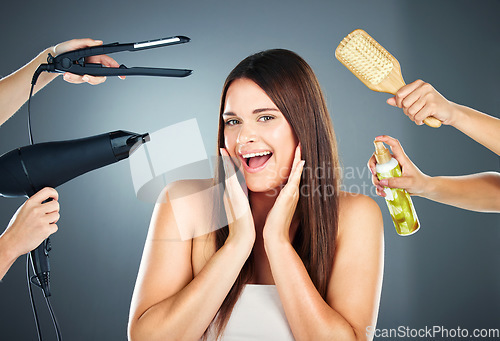 Image of Hair, tools and portrait of woman with haircare products for beauty, cosmetology and wellness on a grey studio background. Brush, hairdryer and spray for hairstyle and hair treatment in a salon
