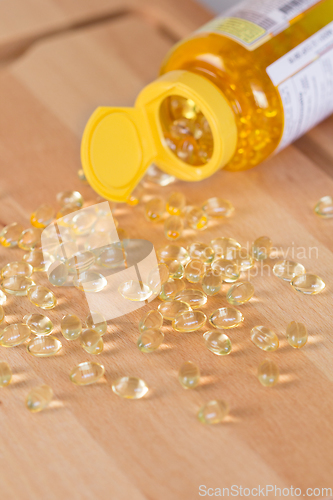 Image of Fish oil omega pills spilled from a bottle