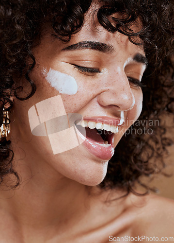 Image of Beauty, skincare and woman with face cream in a studio with a healthy, natural and skin treatment. Wellness, health and happy young model doing a face routine with facial creme, sunscreen or spf.