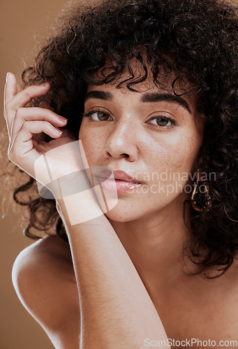 Image of Skincare, hair care and face of woman with beauty, makeup and cosmetics against a brown studio background. Wellness, luxury and portrait of a girl model at a spa or salon for hair or natural skin