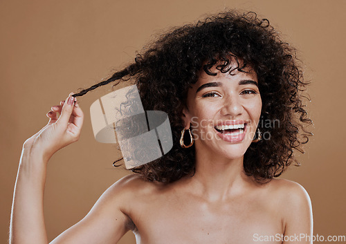 Image of Hair care, growth and woman excited about health, wellness and clean shampoo against a brown studio background. Salon, smile and portrait of a model with hair beauty and shine from hairdresser