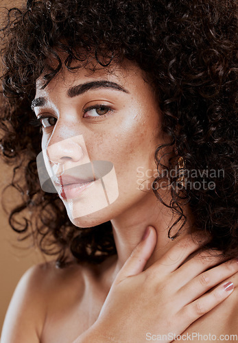 Image of Skincare, hair care and face of a woman with makeup, beauty and natural glow against a brown studio background. Salon, luxury and portrait of a model with cosmetics and wellness care for afro hair