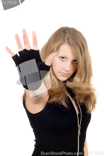 Image of Young girl with hand stop sign. Focus on a face