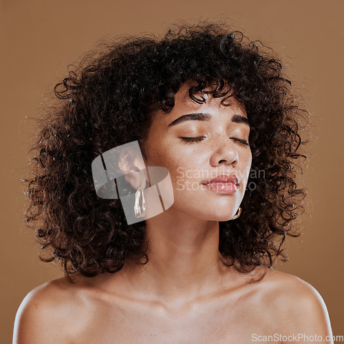 Image of Woman, beauty and freckles, curly hair and facial treatment, makeup and body care aesthetics, shine or glow on studio background. Young model, melasma face and natural cosmetics, skincare or wellness