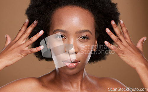 Image of Hair care, beauty and portrait of a black woman with a wellness, health and curly routine in studio. Skincare, face and African model with natural hair and skin treatment isolated by brown background