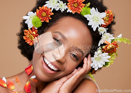 Image of Beauty, art and black woman with flower crown in hair and smile on face, portrait with studio background. Nature, happy woman with flowers, natural skincare or hair care with sustainable ingredients.