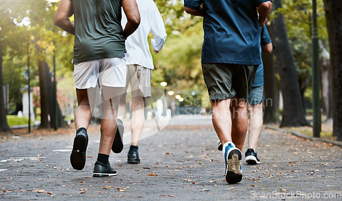 Image of Fitness, men and running club in park, cropped legs in nature for exercise on garden path together. Motivation, workout and friendship, group of senior friends run, health and wellness in retirement.