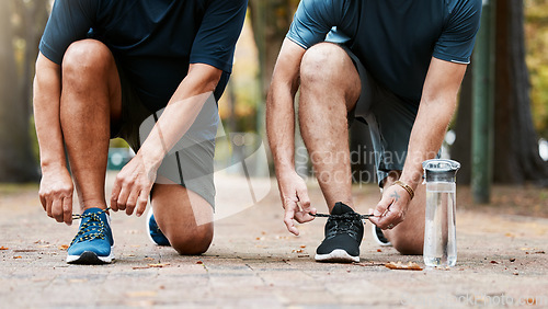 Image of Fitness, run and men friends tying their shoes while doing an outdoor cardio workout in the city. Sports, footwear and male athletes running for exercise or training for marathon, race or competition