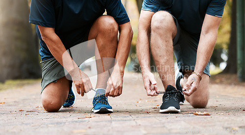 Image of Legs, tie lace and sports running team for fitness or healthcare exercise outdoors. Healthy men, teamwork training workout and marathon wellness collaboration or check shoelace for run in nature park