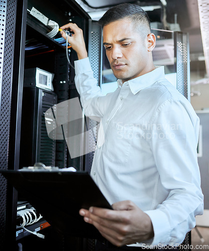 Image of Server room, database and IT support with a man programmer working on an information storage solution. Documents, cybersecurity and cloud computing with a male coder at work in a data center