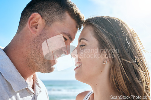 Image of Couple, love and happy smile at beach, holiday and anniversary travel in summer with romance in Ibiza. Young man and woman enjoy marriage, happiness and content together outdoor at a ocean vacation