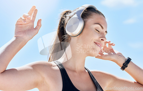 Image of Music, summer and dance with a woman outdoor in nature against a blue sky for dancing or freedom. Radio, relax and carefree with an attractive young female streaming or listening to audio outside