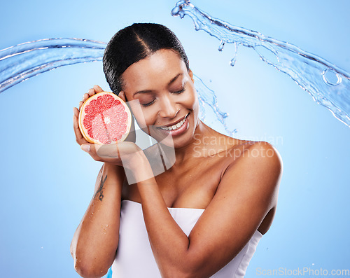 Image of Water splash, grapefruit and skincare of a black woman holding fruit, diet food and nutrition. Vitamin c, cosmetic health and wellness of a model with water happy about zen beauty and healthy eating