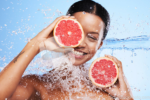 Image of Grapefruit, black woman and water splash, vitamin c beauty and skincare wellness, healthy body and aesthetics, natural cosmetics and face on studio background. Portrait model, wet citrus and detox