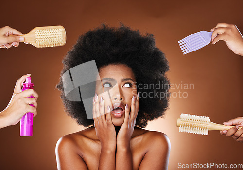 Image of Black woman thinking of hair care, tools for natural afro and decision making of beauty products. Shocked african girl with choices, salon brushes and hairspray in studio with dark brown background