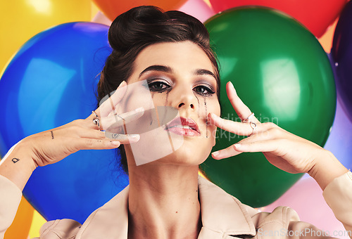 Image of Face, beauty and makeup with a model woman in studio against a balloon background for fashion or style. Portrait, party and sad with an attractive young female posing with balloons at a birthday